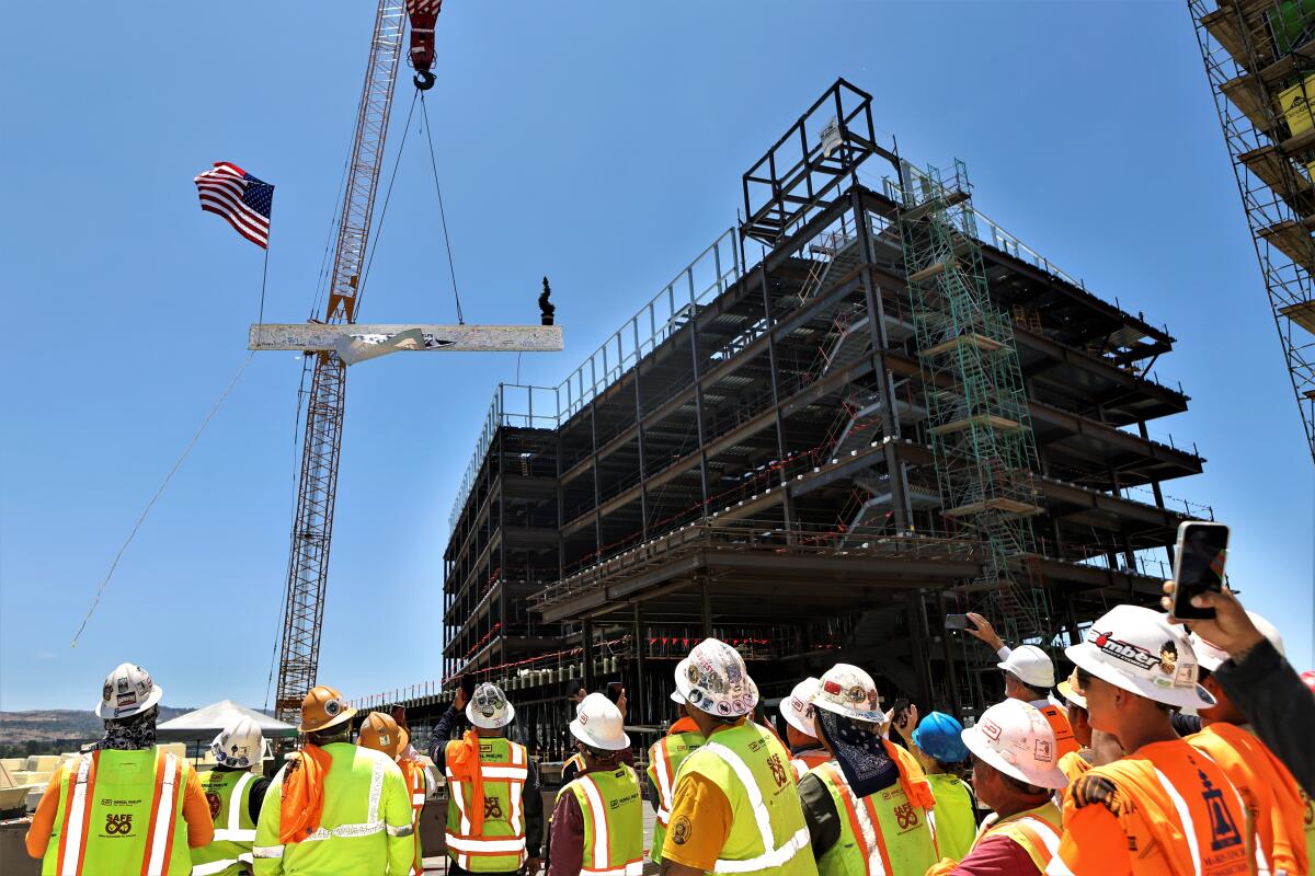 A beam is hoisted Thursday atop what will be part of a new $1.3-billion UCI Health campus in Irvine.