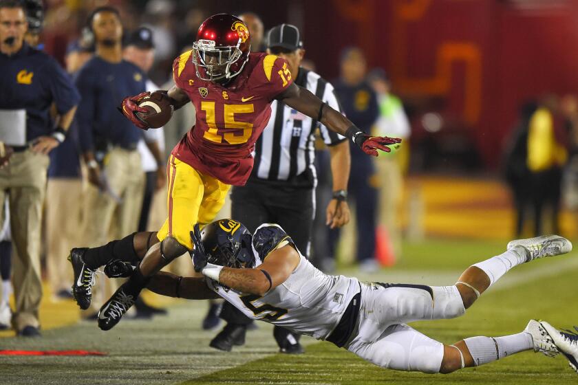 USC receiver Nelson Agholor is pushed out of bounds by California safety Michael Lowe during the first half of the Trojans' 38-30 win over the Golden Bears on Nov. 13.