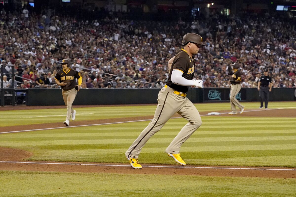 Padres designated hitter Luke Voit, right, walks with the bases loaded Thursday.
