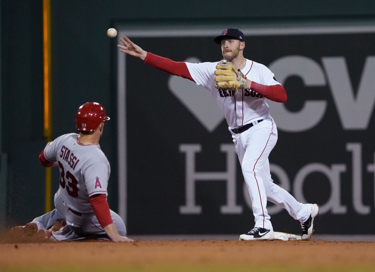Boston Red Sox second baseman Trevor Story throws to first after forcing out Angels' Max Stassi.