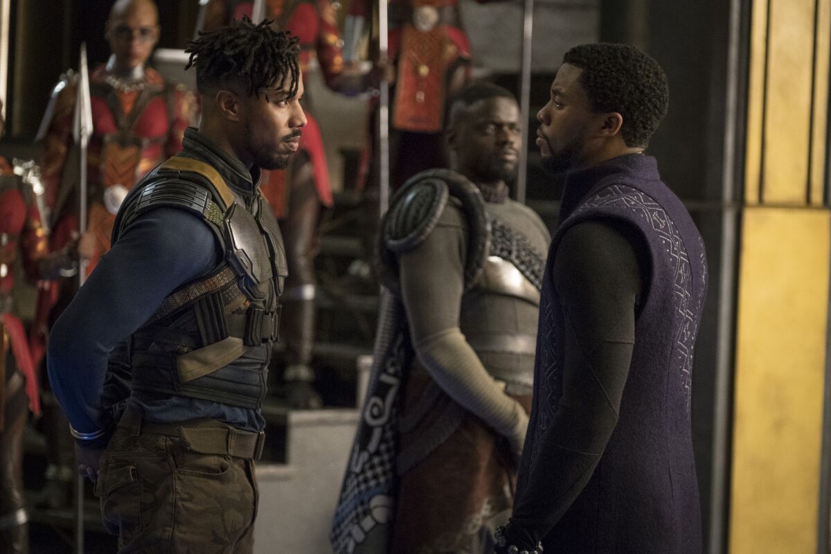 Michael B. Jordan, left, and Chadwick Boseman (with Daniel Kaluuya in the background) in a scene from "Black Panther."