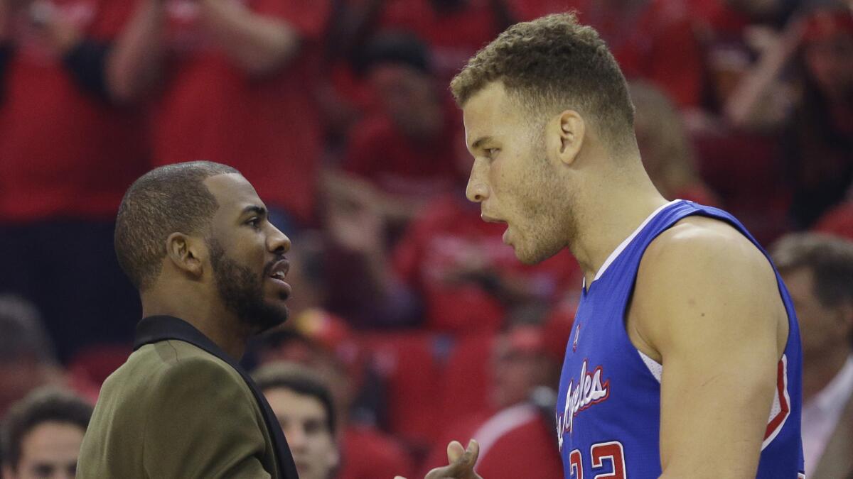 Clippers point guard Chris Paul didn't dress for the game because of a hamstring injury, but here he consults with Blake Griffin during the Clippers' 117-101 victory over the Houston Rockets in Game 1 of the Western Conference semifinals on May 4, 2015.