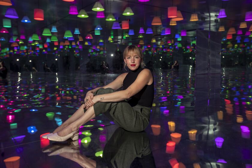 LOS ANGELES, CA - APRIL 26, 2021: Paige Solomon, CEO and Creative Director of the Madcap Motel, an art installation in Los Angeles with a 1960's vibe, is photographed inside room 226, where mirrors create the illusion of infinite lamps. The Madcap Motel opens to the public on April 30, 2021. (Mel Melcon / Los Angeles Times)
