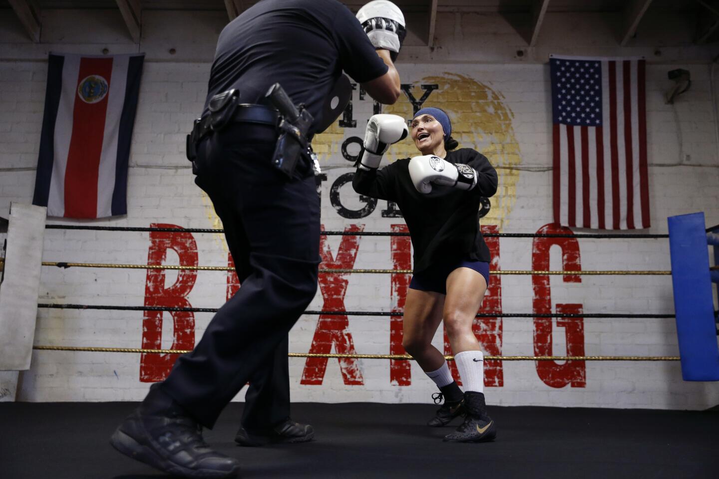 Deirdre Fonseca, 31, right, Los Angeles Police Department officer, trains with Officer John Negrete, LAPD Boxing Team director, at the City of Angels Boxing gym in Los Angeles, Calif.