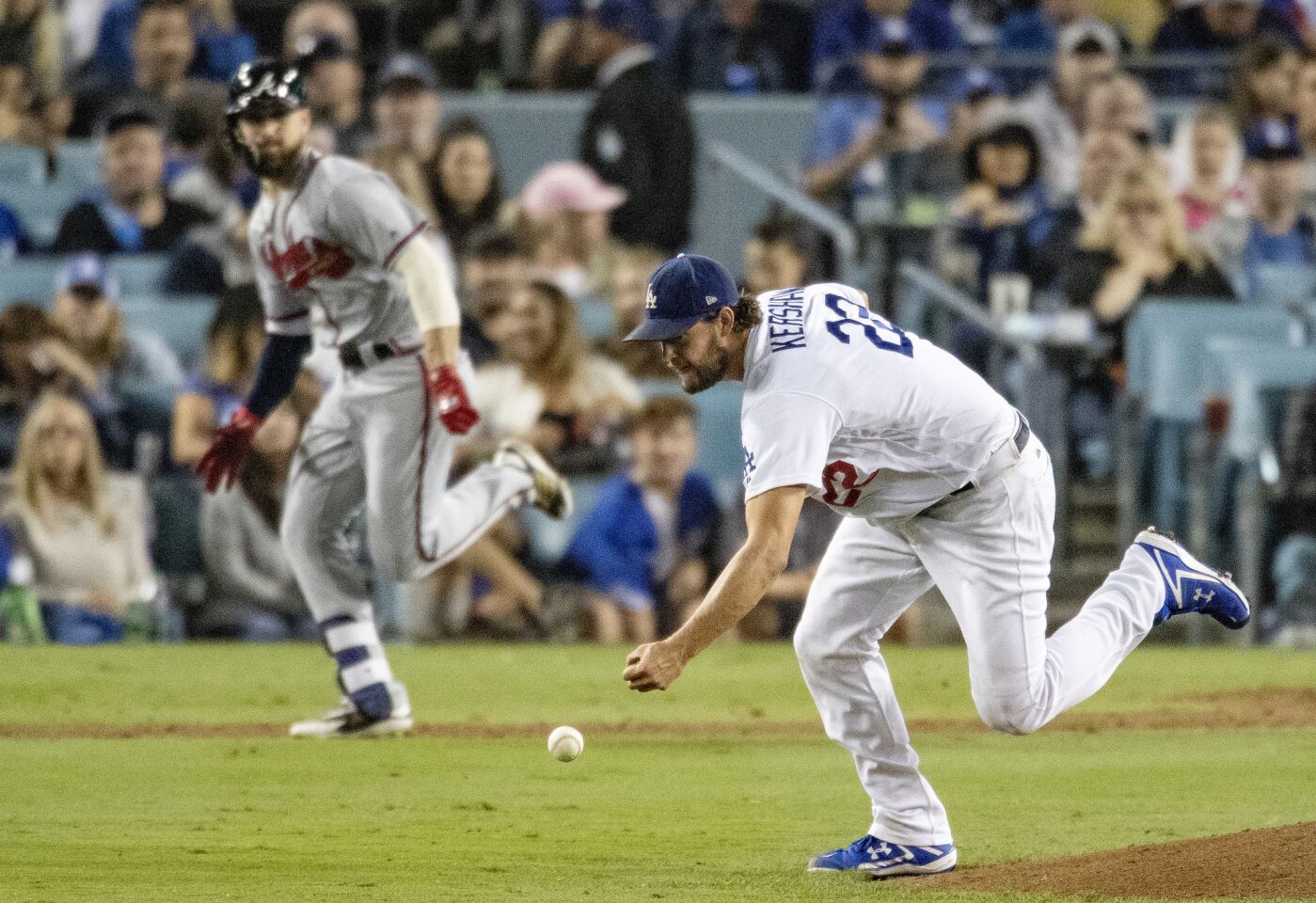 Dodgers starting pitcher Clayton Kershaw can't get a hand on an infield hit by Atlanta Braves center fielder Ender Inciarte.