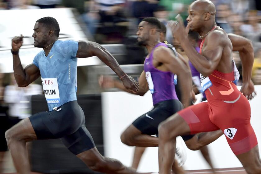 Justin Gatlin pulls ahead of Tyson Gay (purple) and Asafa Powell (red) in the men's 100-meter dash at the IAAF Diamond League meet in Lausanne, Switzerland, on Thursday.
