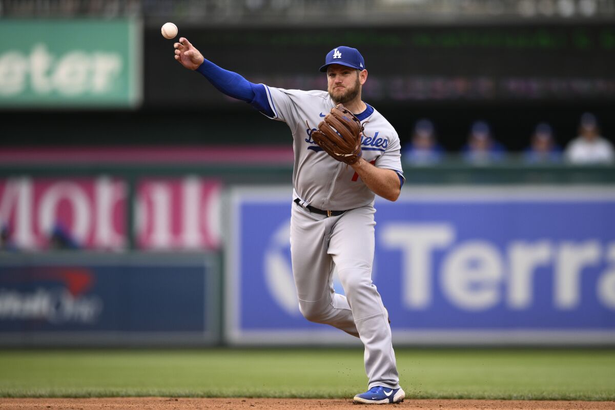 Dodgers second baseman Max Muncy throws to first against the Washington Nationals on Wednesday.