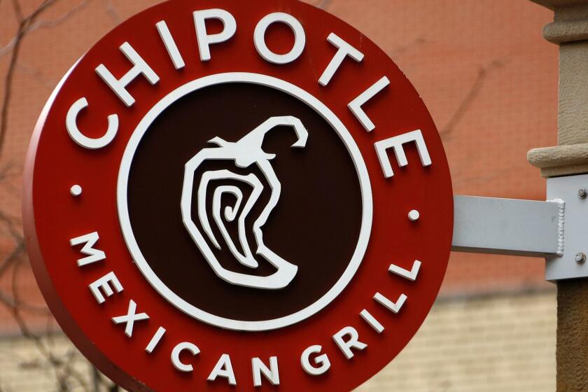 FILE- This Jan. 12, 2017, file photo shows the sign on a Chipotle restaurant in Pittsburgh. Chipotle is moving its headquarters from its hometown of Denver to southern California, the burrito chain announced Wednesday, May 23, 2018. (AP Photo/Gene J. Puskar, File)
