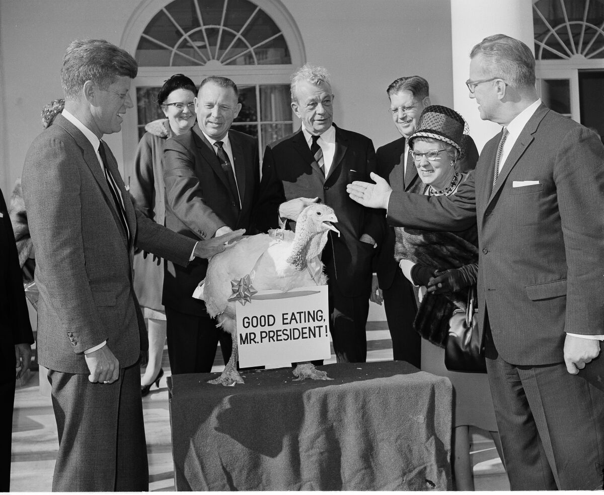 President Kennedy, left, with a turkey presented to him at the White House in 1963.
