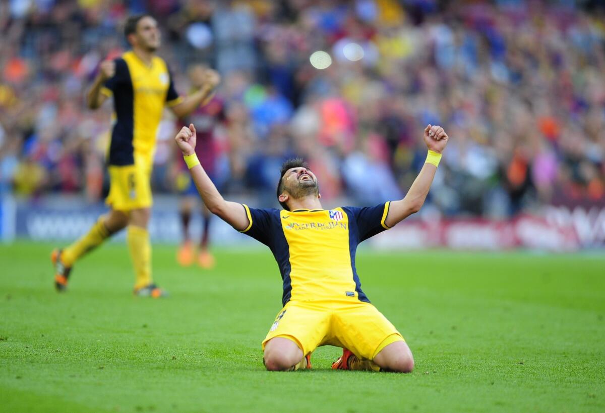 David Villa celebrates after Atletico Madrid clinched the La Liga title with a 1-1 draw with Barcelona on May 17. Atletico Madrid and Real Madrid will play for the Champions League title Saturday.