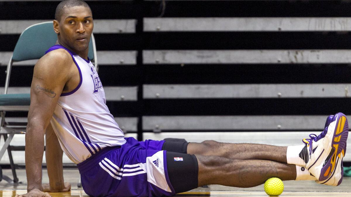 Lakers forward Metta World Peace stretches courtside during a practice in Hawaii.