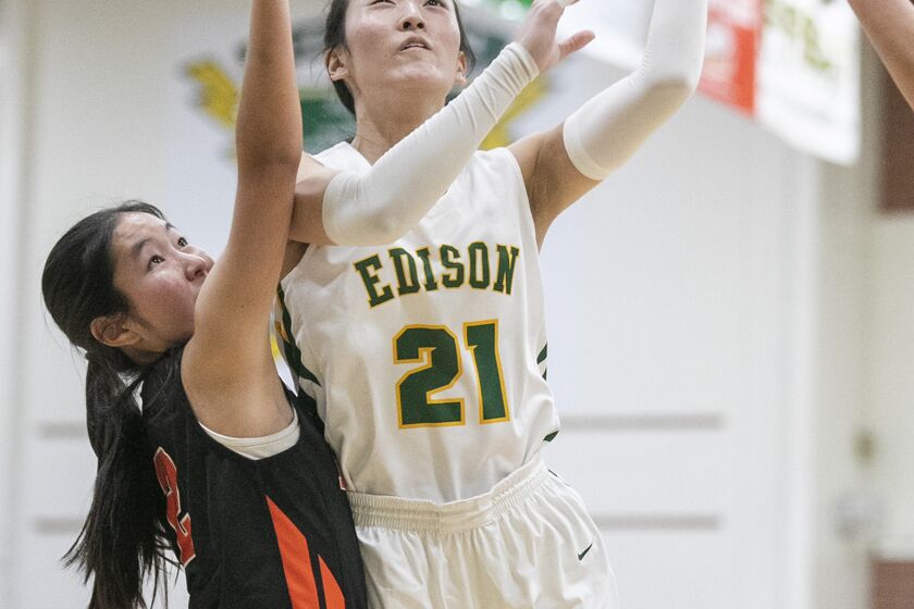 Edison's Bailey Chang goes up for a shot against Huntington Beach's Traci Ann Mori during a Wave League game on Thursday.