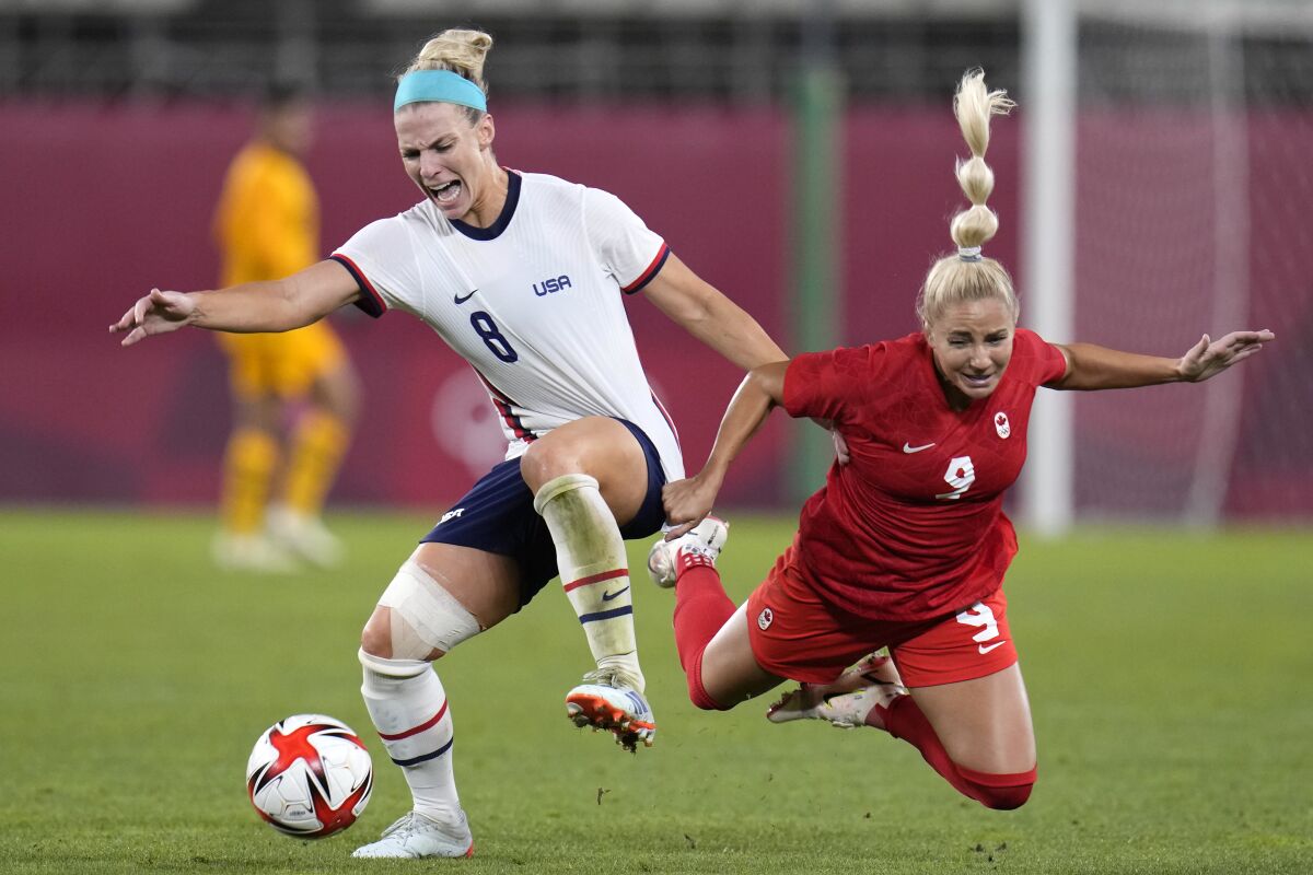 FILE - United States' Julie Ertz, left, battles Canada's Adriana Leon, right, for the ball during a women's semifinal soccer match at the 2020 Summer Olympics, Monday, Aug. 2, 2021, in Kashima, Japan. Ertz was named to the U.S. national team roster for a pair of upcoming matches against Ireland next after taking time off for the birth of her son. Ertz was among 26 players named to the roster, announced by coach Vlatko Andonovski on Tuesday, March 28, 2023. (AP Photo/Fernando Vergara, File)