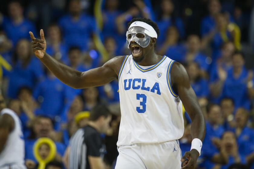 UCLA forward Adem Bona (3) celebrates after scoring against Arizona during the second half of an NCAA college basketball game Saturday, March 4, 2023, in Los Angeles. (AP Photo/Ringo H.W. Chiu)