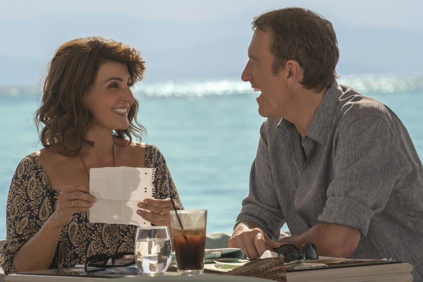 This image released by Focus Features shows Nia Vardalos, left, and John Corbett in a scene from "My Big Fat Greek Wedding 3." (Yannis Drakoulidis/Focus Features via AP)