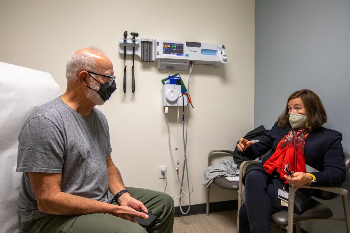 A doctor places a stethoscope on a patient 