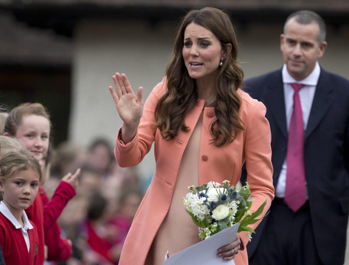 The Duchess of Cambridge waves goodbye to schoolchildren after an official visit to Naomi House near Winchester, England.