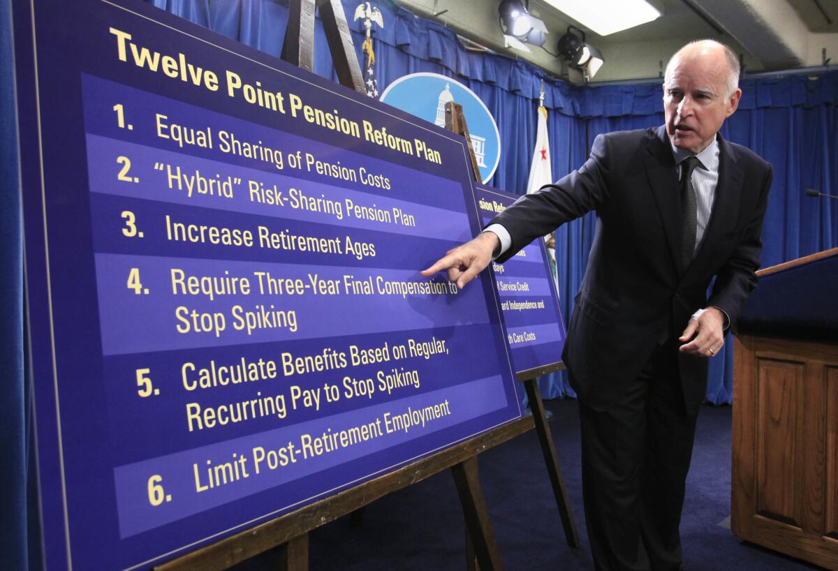 Gov. Jerry Brown gestures to a chart in 2011 showing proposals to roll back public employee pension benefits