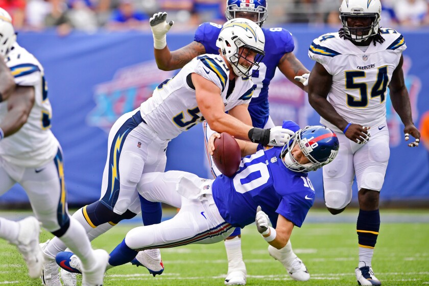Chargers defensive end Joey Bosa sacks Giants quarterback Eli Manning during the first quarter of Sunday's game.
