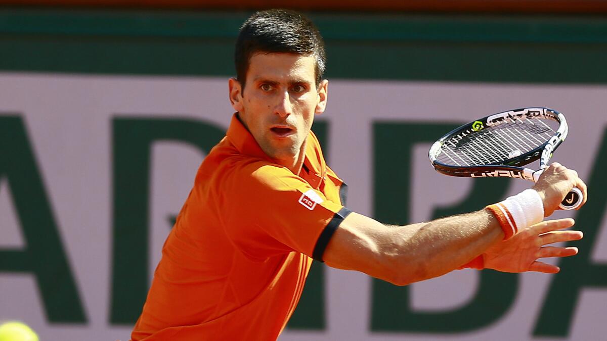 Novak Djokovic hits a return during his victory over Rafael Nadal in the French Open quarterfinals on June 3, 2015.