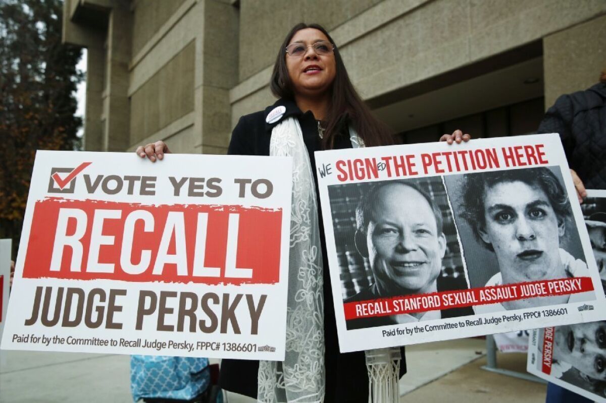 Ana Gabriela Hermosillo joins in a protest calling for the recall of Santa Clara County Judge Aaron Persky at the Santa Clara County Registrar of Voters office in San Jose, Calif., Thursday, Jan. 11, 2018.