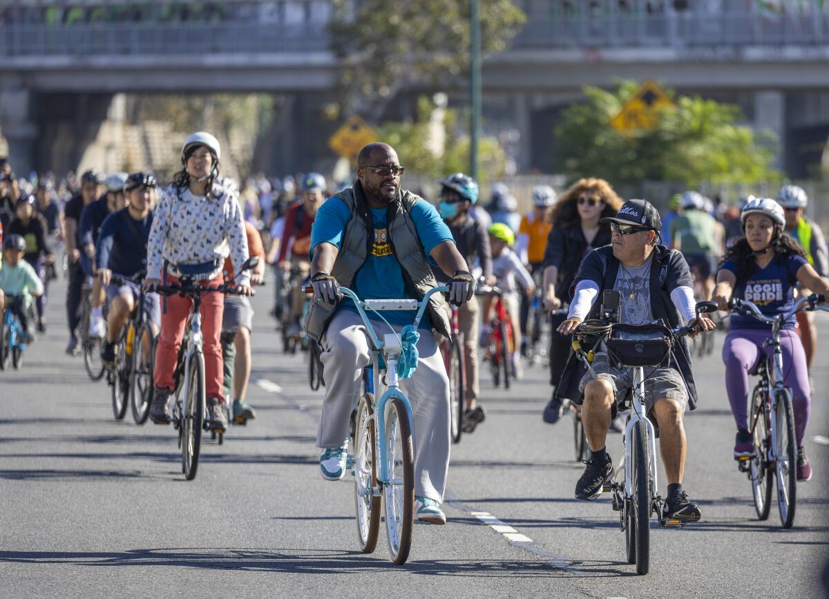 Cyclists ride on the 110 Freeway. 