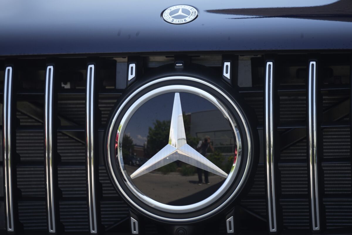 In this Sunday, July 25, 2021, the Mercedes Benz company logo is shown a Mercedes Benz dealership in Littleton, Colo. A few days after reports surfaced that Tesla allows drivers to play video games on dashboard touch screens while vehicles are moving, Mercedes-Benz has issued a U.S. recall for a similar issue. The German automaker said in documents posted Friday, Dec. 10, by U.S. regulators that the issue affected 227 vehicles and already has been fixed by updating an internal computer server.(AP Photo/David Zalubowski, File)