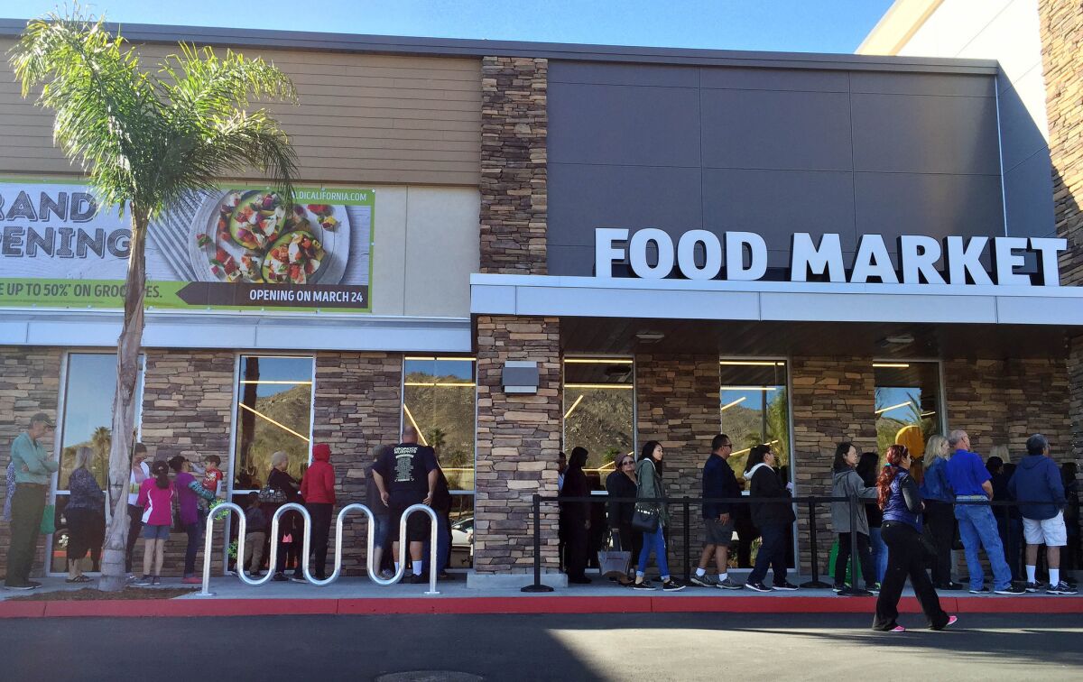 Long lines for outside the Moreno Valley location of Aldi. The dicount grocer is opening eight Southern California stores.