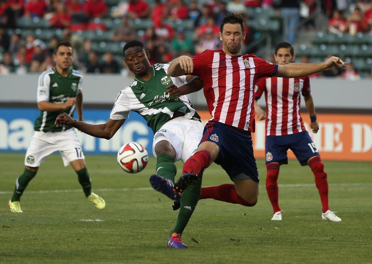Chivas USA's Bobby Burling, right, and Portland's Frederic Piquionne battle for the ball during the first half of the Timbers' 2-0 victory Wednesday at StubHub Center.