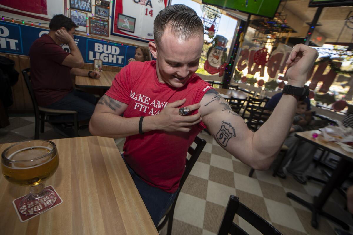 Brendan Kelly shows off a tattoo of "Route 91," the name of the Las Vegas festival where he survived a mass shooting that killed dozens. He recently added two names to his tattoo — Telemachus Orfanos and Justin Meek.
