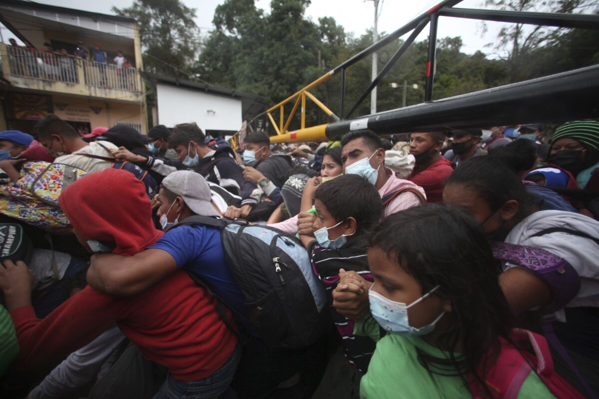 Honduran migrants cross the border patrolled by Guatemalan soldiers at the El Florido crossing.