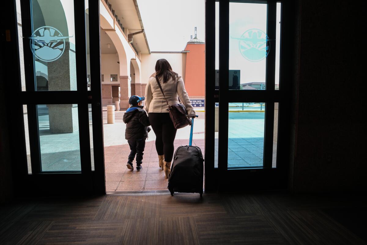 Luz  and her son, Joshua, leaves airport. 