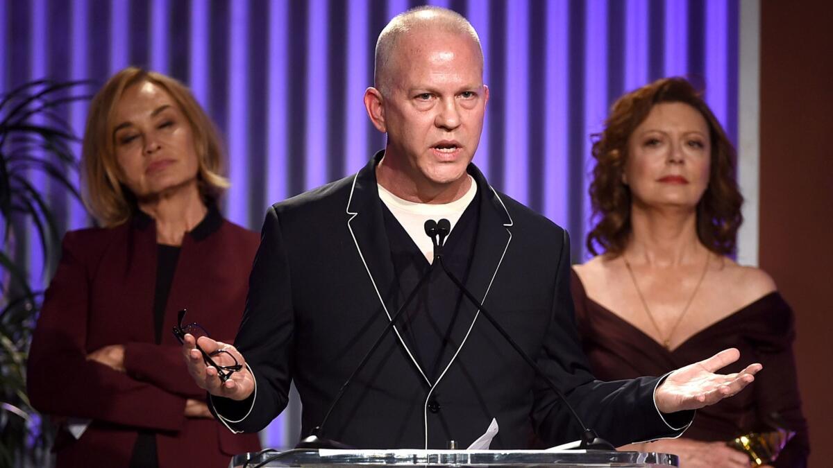 Jessica Lange, left, honoree Ryan Murphy and Susan Sarandon appear onstage during the Dec. 7 Hollywood power breakfast.