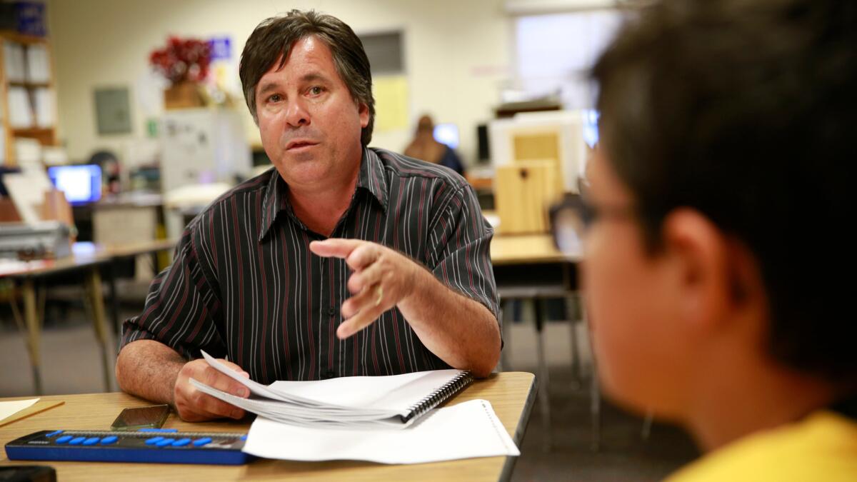 Keith Christian, who teaches blind and visually impaired students, works with Brennan Lamarra, 12, a blind sixth-grade student, during class at Clara Barton Elementary School in Anaheim.