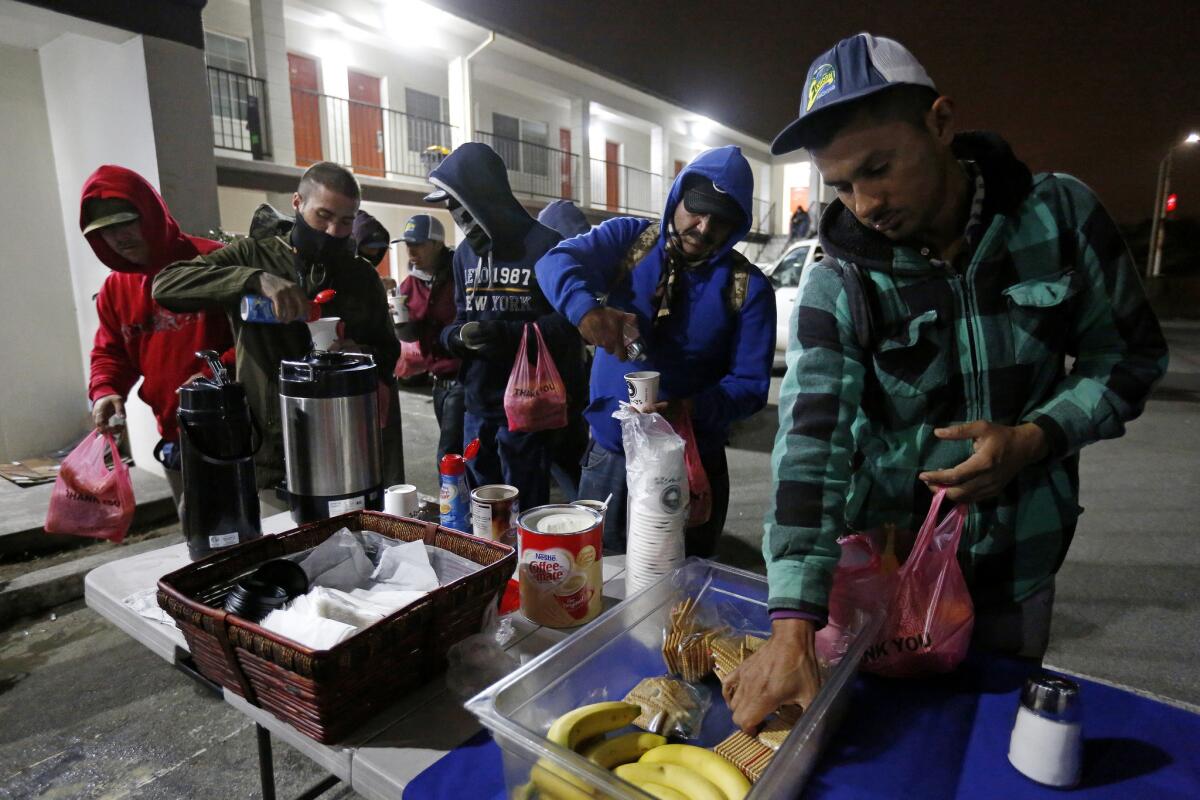 Seasonal agricultural workers holding H-2A visas have breakfast in Salinas.