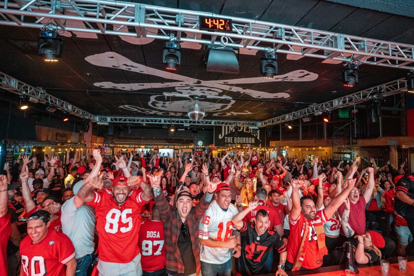 Fans cheer at a past Super Bowl Party hosted by The Deck at Moonshine Flats.