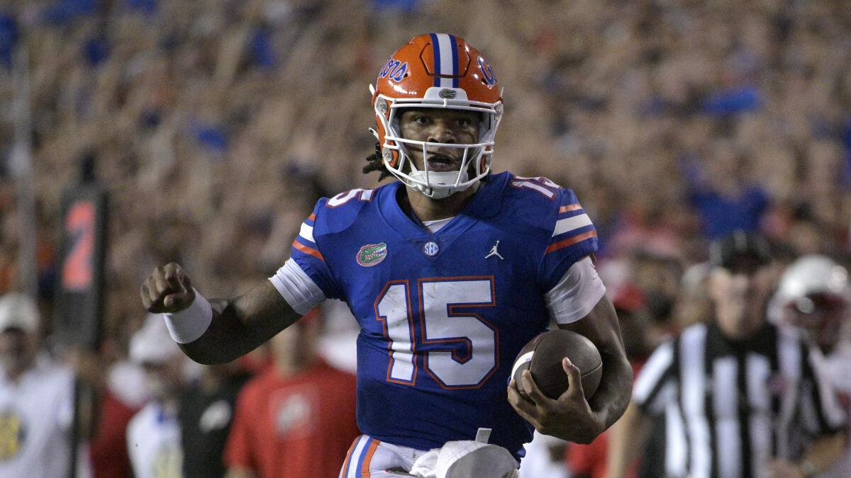 Florida quarterback Anthony Richardson holds out a fist while holding the ball with the other hand.