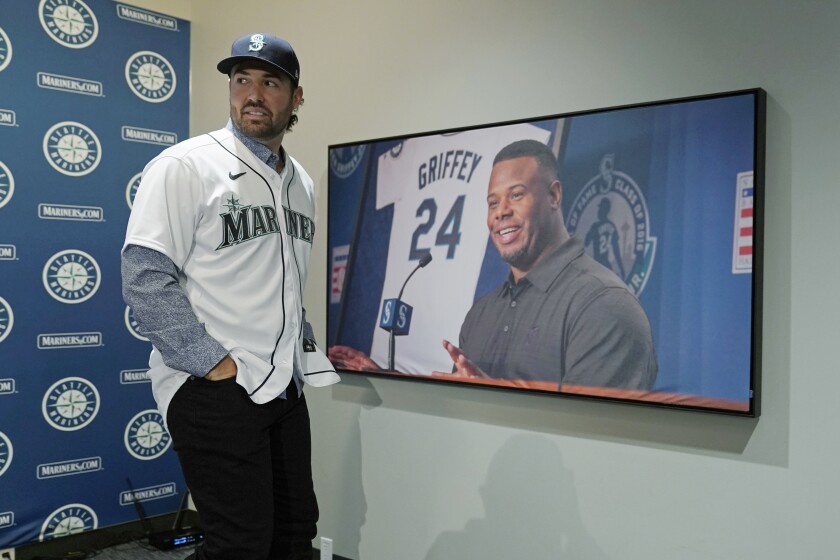 Seattle Mariners pitcher Robbie Ray walks past a photo of Hall-of-Famer Ken Griffey Jr., Wednesday, Dec. 1, 2021, following a news conference in Seattle. The AL Cy Young Award winner — who previously pitched for the Toronto Blue Jays — signed a five-year contract with the Mariners. (AP Photo/Ted S. Warren)