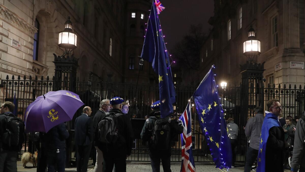 Pro and Anti Brexit campaigners stand outside the entrance to Downing Street in London on March 20.