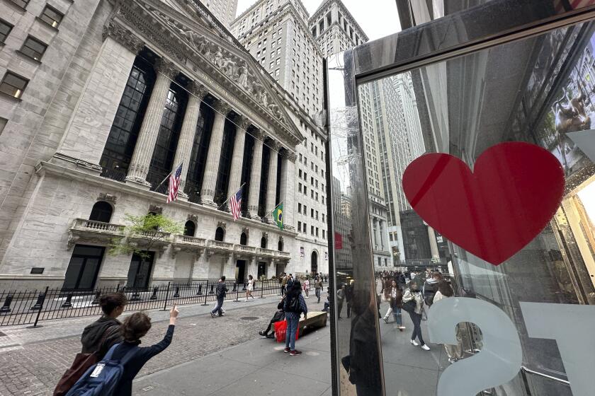 A heart is displayed on the door of a gift shop across from the New York Stock Exchange on Thursday, May 16, 2024, in New York. The Dow Jones Industrial Average briefly topped the 40,000 level on Thursday for the first time but ended 0.1% lower. (AP Photo/Peter Morgan)