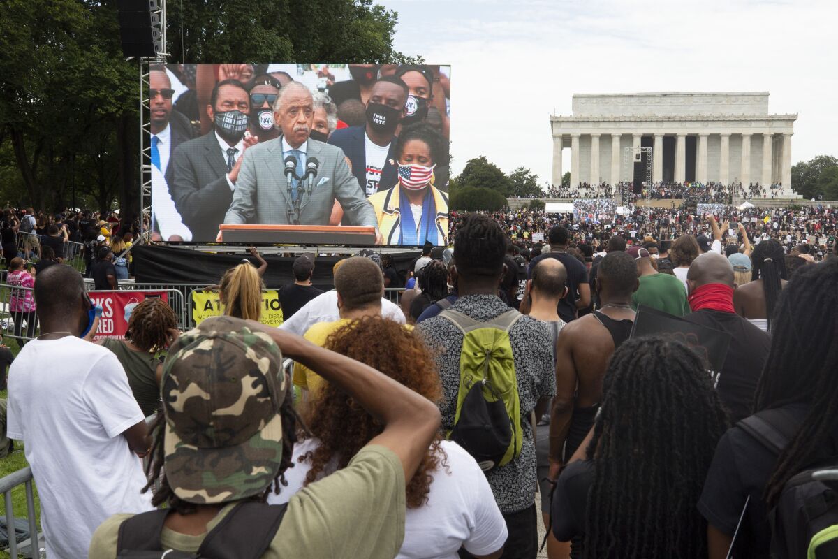 Rev. Al Sharpton speaks to demonstrators during a rally for the National Action Committee's "Get Your Knee Off Our Necks."