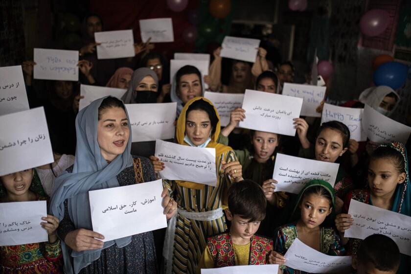 FILE - Women and teachers demonstrate inside a private school to demand their rights and equal education for women and girls, during a gathering for National Teachers Day, at a private school in Kabul, Afghanistan, Oct. 5, 2021. (AP Photo/Ahmad Halabisaz, File)
