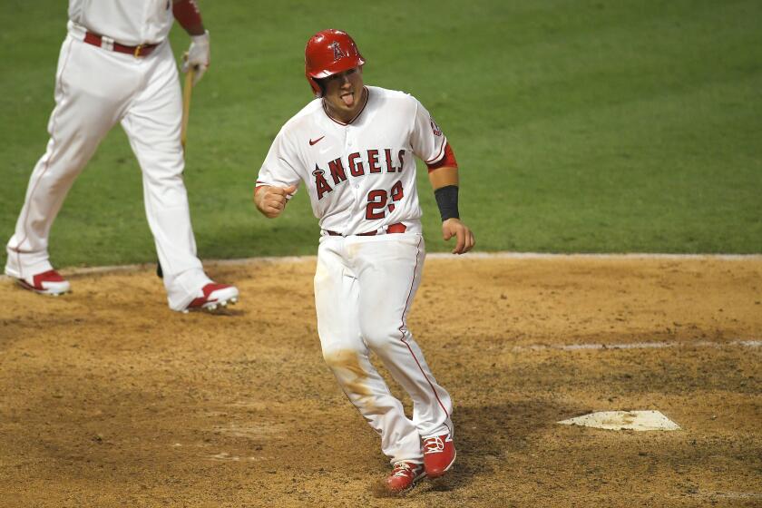 Los Angeles Angels' Matt Thaiss reacts after scoring on a sacrifice fly hit by Michael Hermosillo to win a baseball game during the 10th inning against the Houston Astros Saturday, Aug. 1, 2020, in Anaheim, Calif. (AP Photo/Mark J. Terrill)