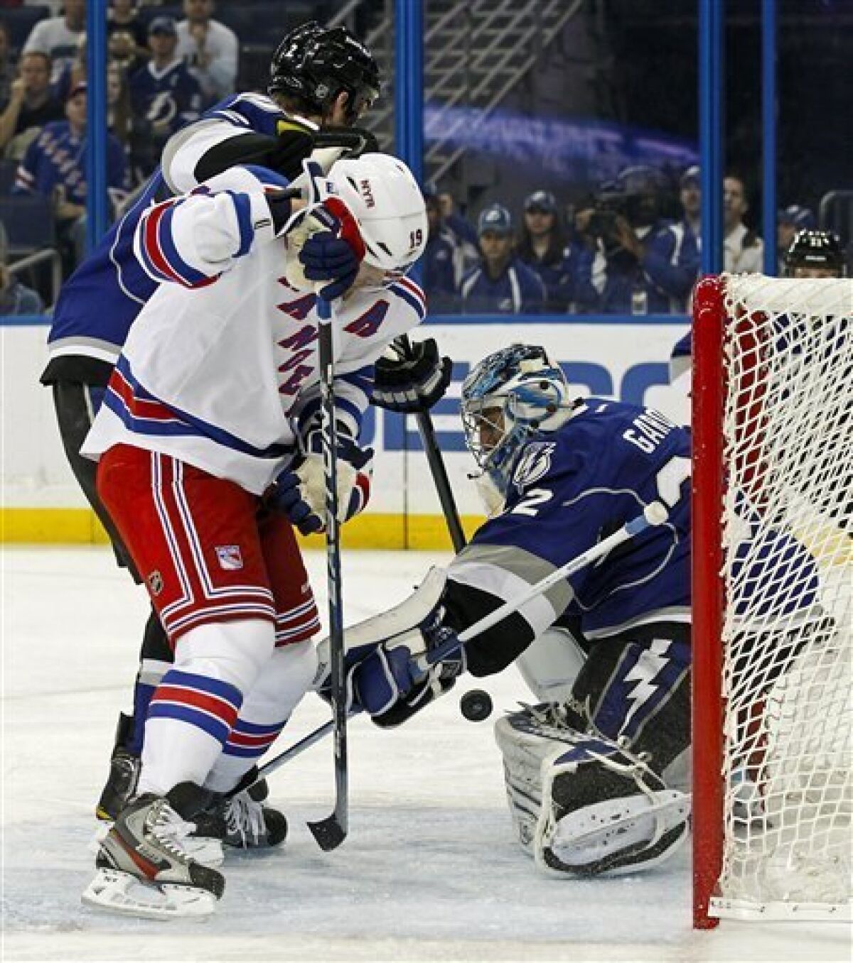 Tampa Bay Lightning goalie Mathieu Garon, right, makes a save in front of New York Rangers' Brad Richards during the first period of an NHL hockey game on Saturday, Dec. 3, 2011, in Tampa, Fla. (AP Photo/Mike Carlson)