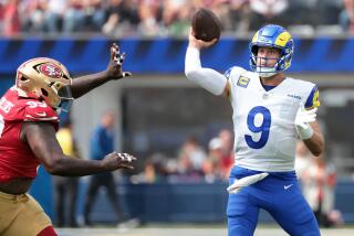 Rams quarterback Matthew Stafford throws a pass in front of 49ers defensive lineman Malik Collins.