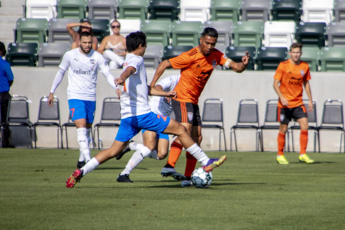 Orange County's Michael Orozco executes a tackle against a Rio Grande Valley FC player in the first half on Saturday.