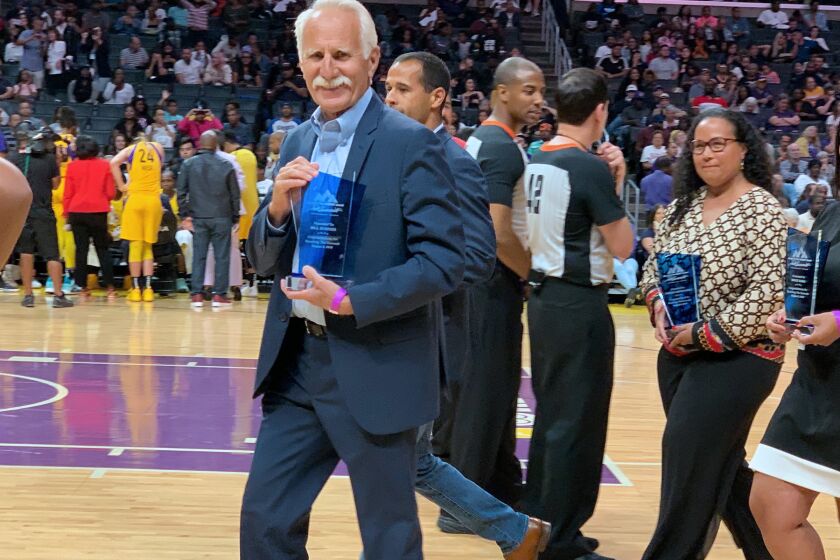 Corona del Mar High cross-country and track and field coach Bill Sumner received an award for leadership in the field of sports and coaching at halftime of the Los Angeles Sparks game on Thursday night at Staples Center. (Courtesy of Hannah Lee)