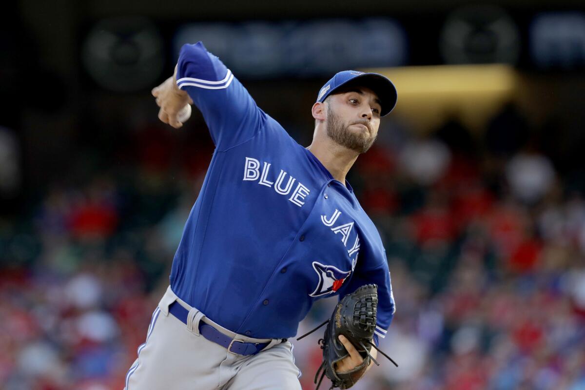 Blue Jays right-hander Marco Estrada (25) throws a pitch against the Texas Rangers during the first inning of Game 1 of the ALDS.