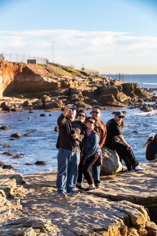 Members of the Quon family (from left, Kevin, Cindy, Kimberly and Kenny) pause for a selfie at the tide pools at Cabrillo National Monument.