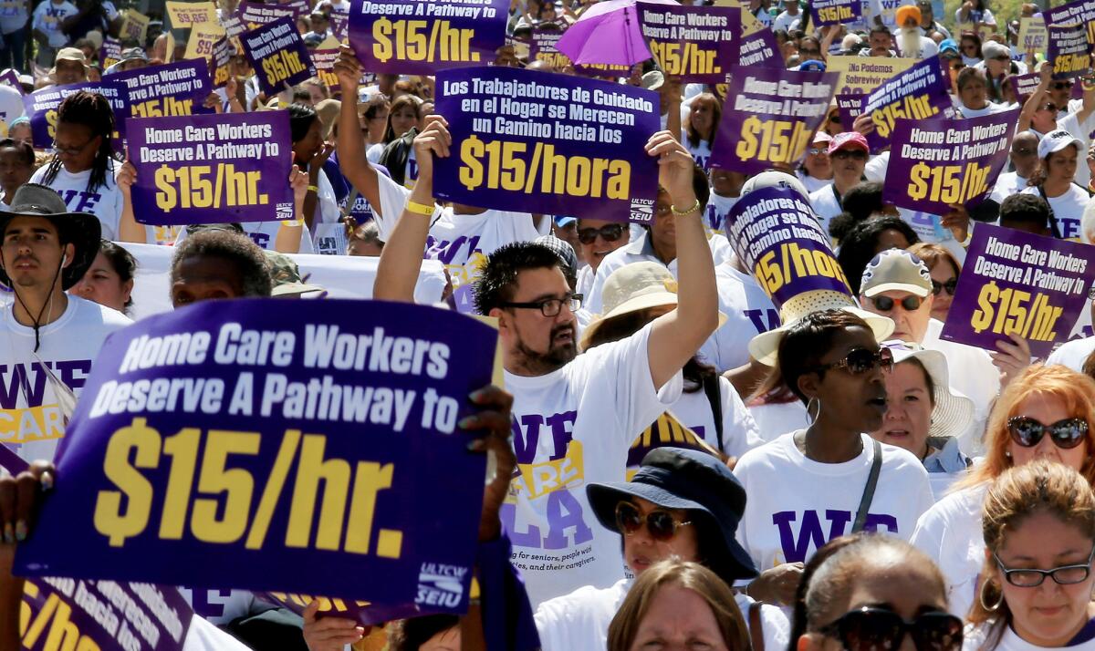 Workers demonstrate in favor a $15-an-hour minimum wage in Los Angeles in April. (Luis Sinco / Los Angeles Times)